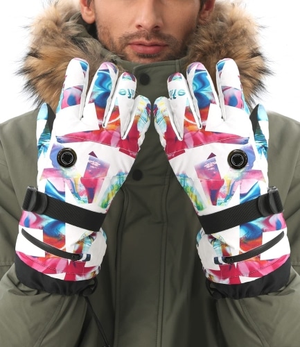 Product photo of white and multi-colored Aroma Season Heated Gloves modeled by a man in a olive green, fur-trimmed coat.