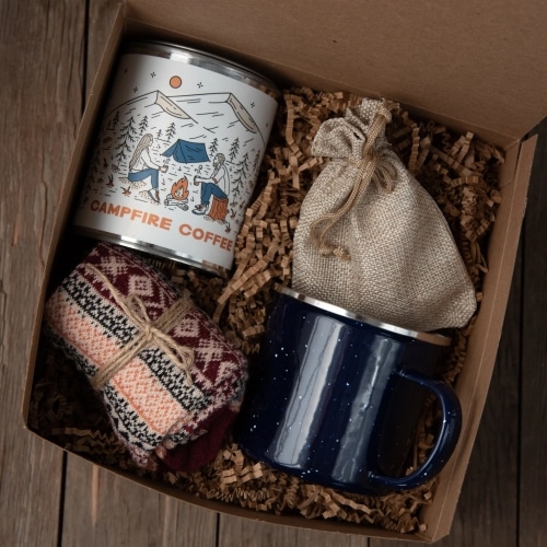Camping Coffee Gift Box with a mug, wool knit socks, 12 oz of coffee, and caramels.