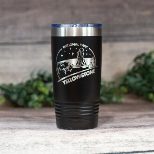A black and silver Yellowstone To-Go Cup with an image of a bison and a geyser.