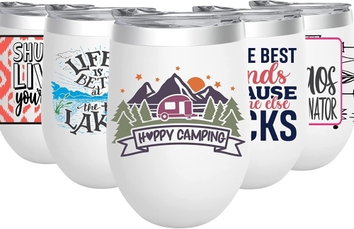 A group of white Biddlebee stainless steel Insulated Wine Tumblers with different graphics. The one in front has an RV on it and says Happy Camping.