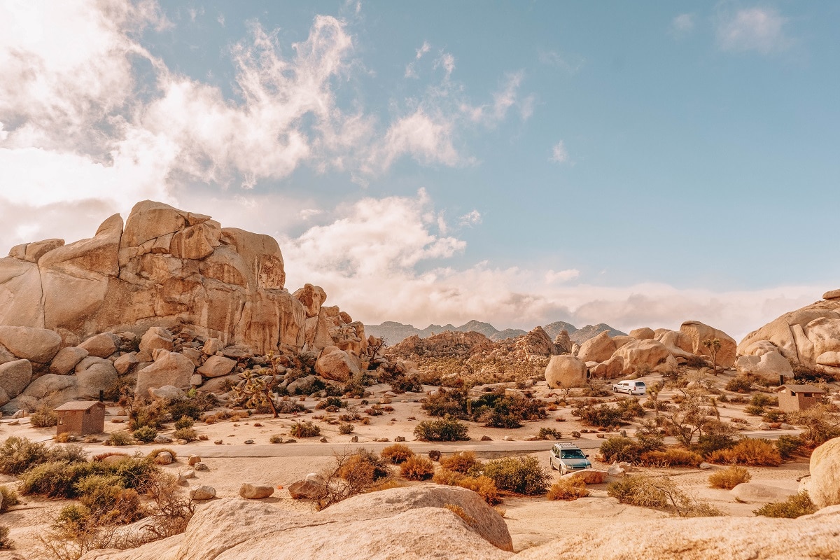 Camp site at Joshua Tree National Park with rocky landscape and sandy dunes