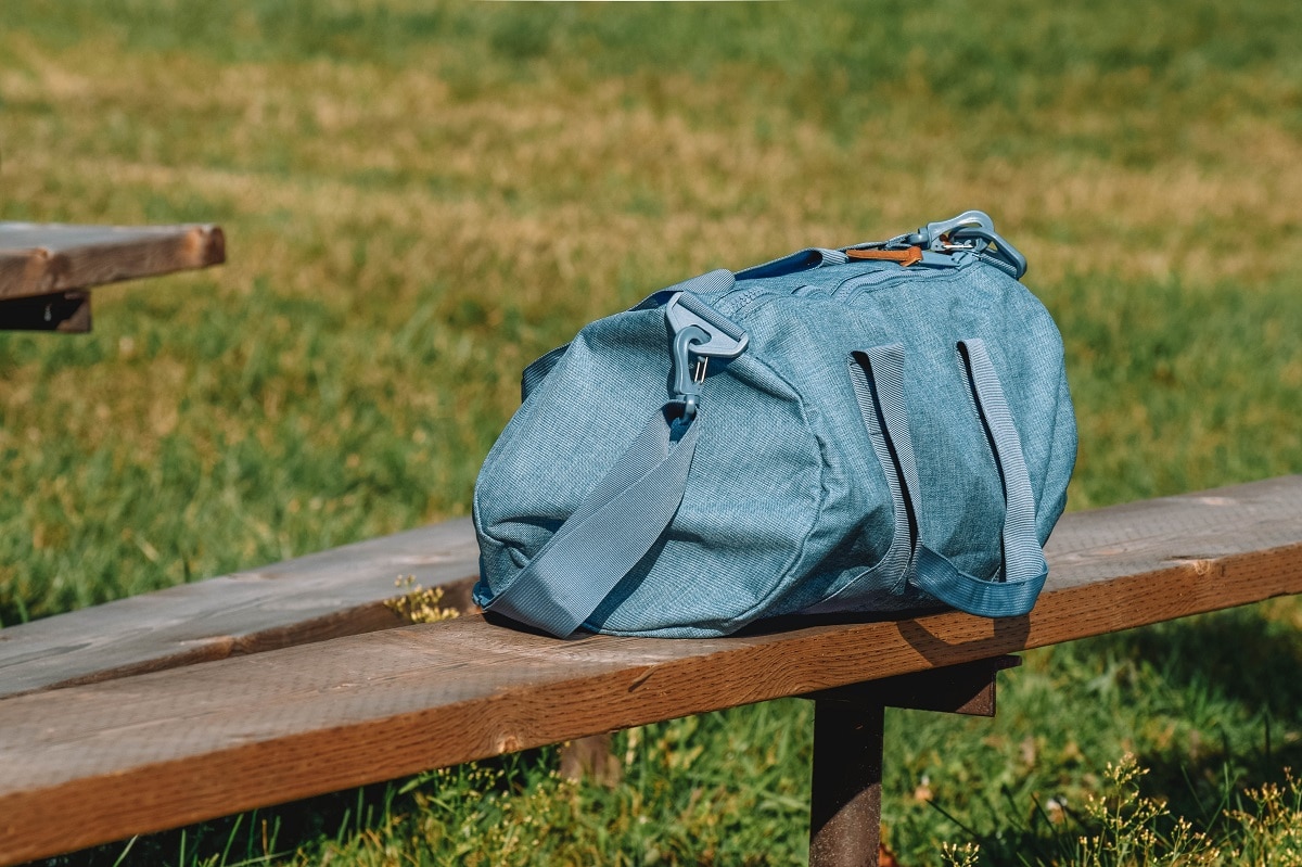 blue duffel bag on bench