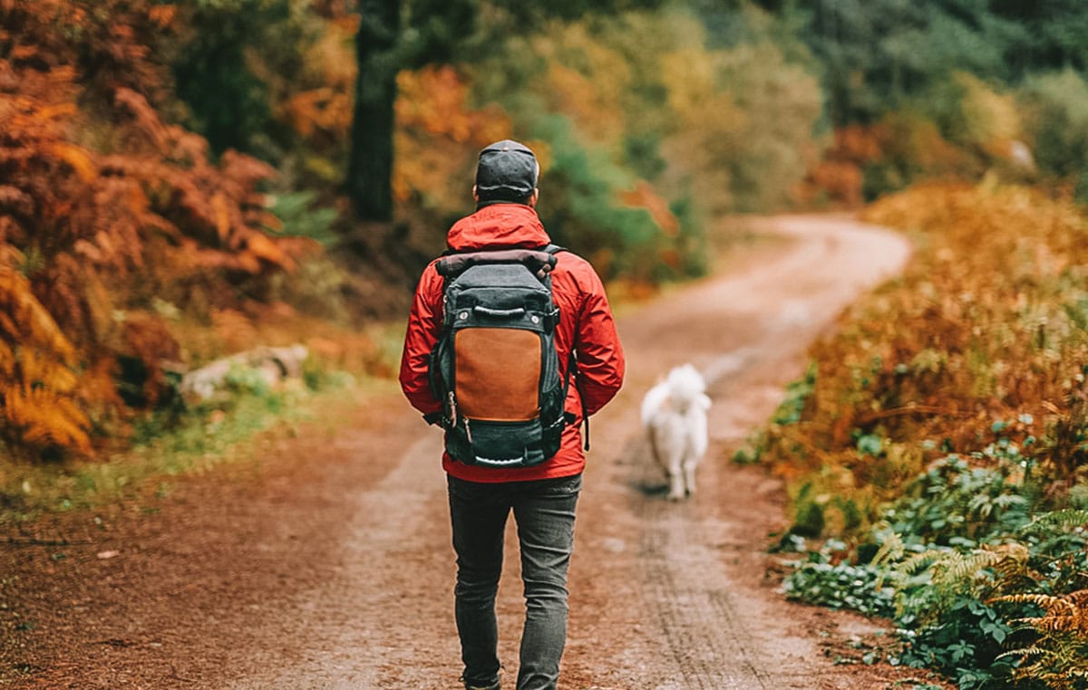 hiker wearing a red coat and a backpack