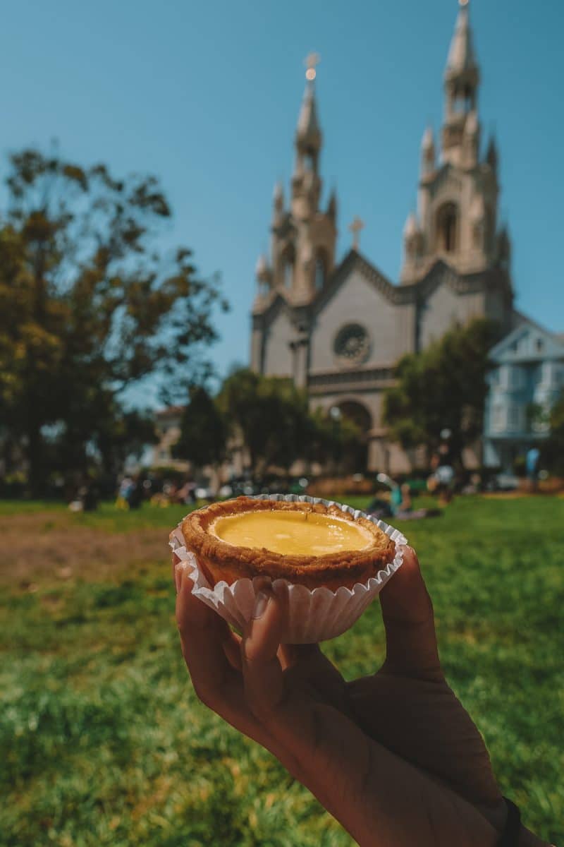 egg tart pastry in front of cathedral at Washington Park in San Francisco.
