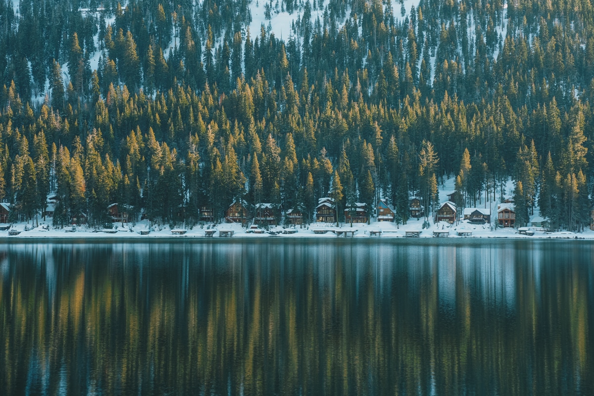 A serene scene of cabins nestled in snow on the lake in Lake Tahoe.