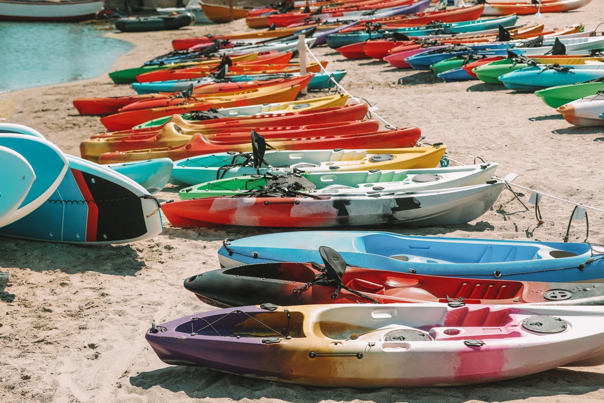 Colorful kayaks on sea sand