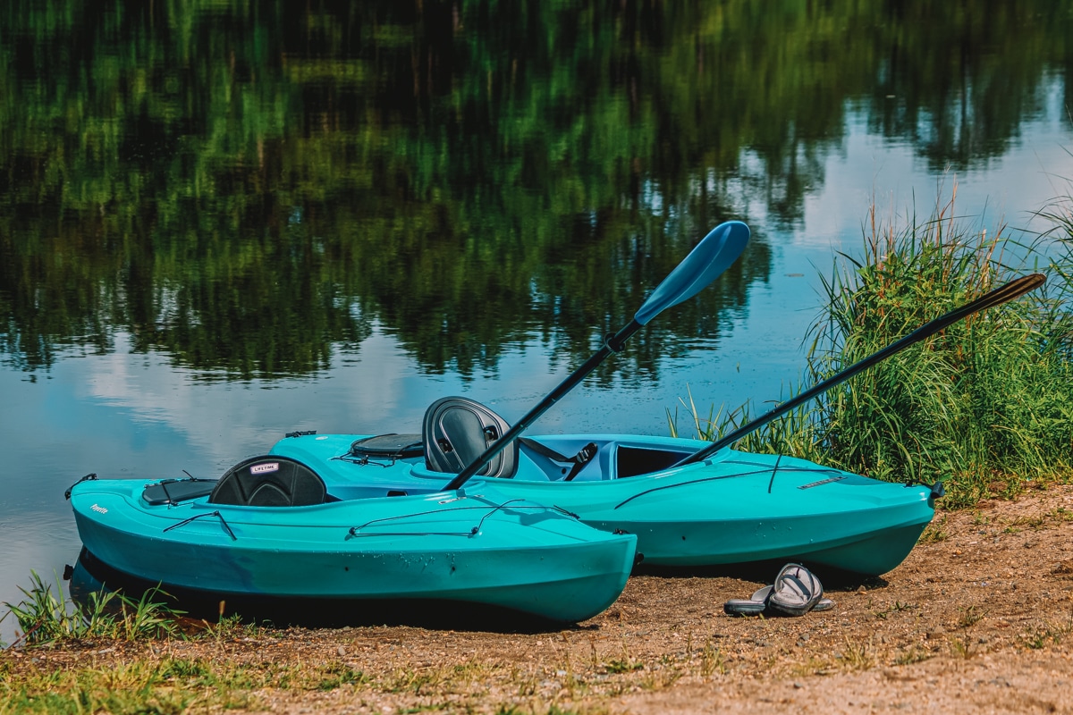 Blue Lifetime kayaks with paddles on the lake