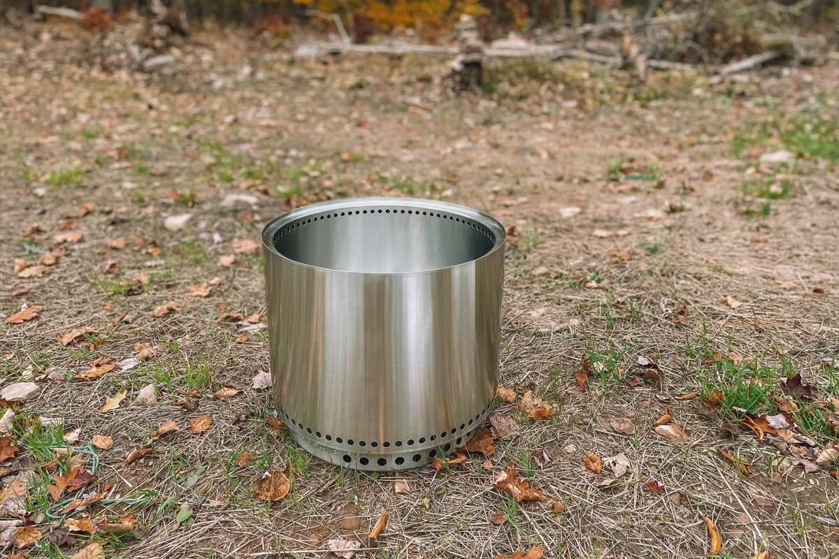 A new Solo Stove bonfire sitting on the ground outdoors.